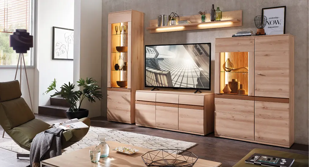 Wohnzimmer mit TV-Möbeln aus Holz, beleuchteten Vitrinen, Sessel und Couchtisch